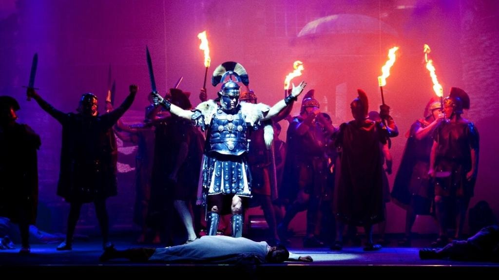 Theatrical production with armor and torches